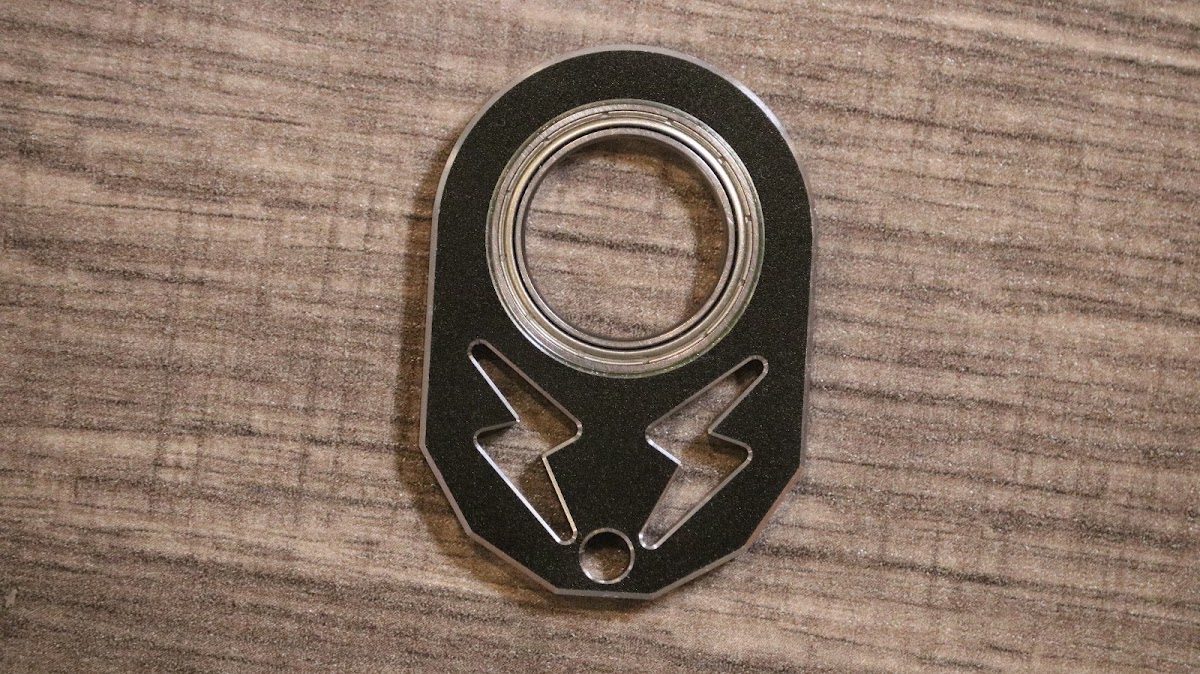 KeyKaram key spinner — precision-machined black fidget spinner with ceramic bearing, top-down view